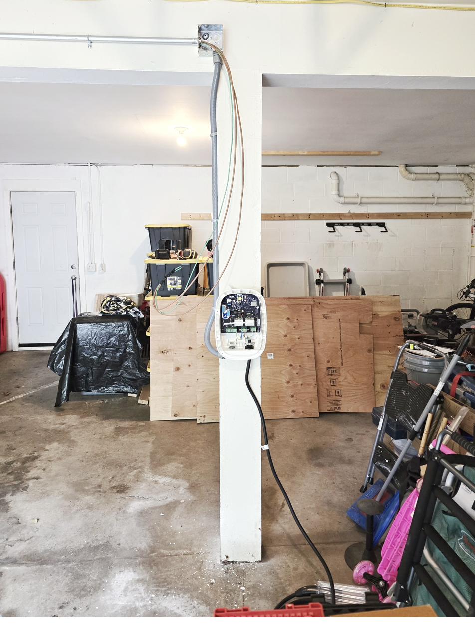 Conduit run from ceiling down post during Emporia EV charger install in Park Forest