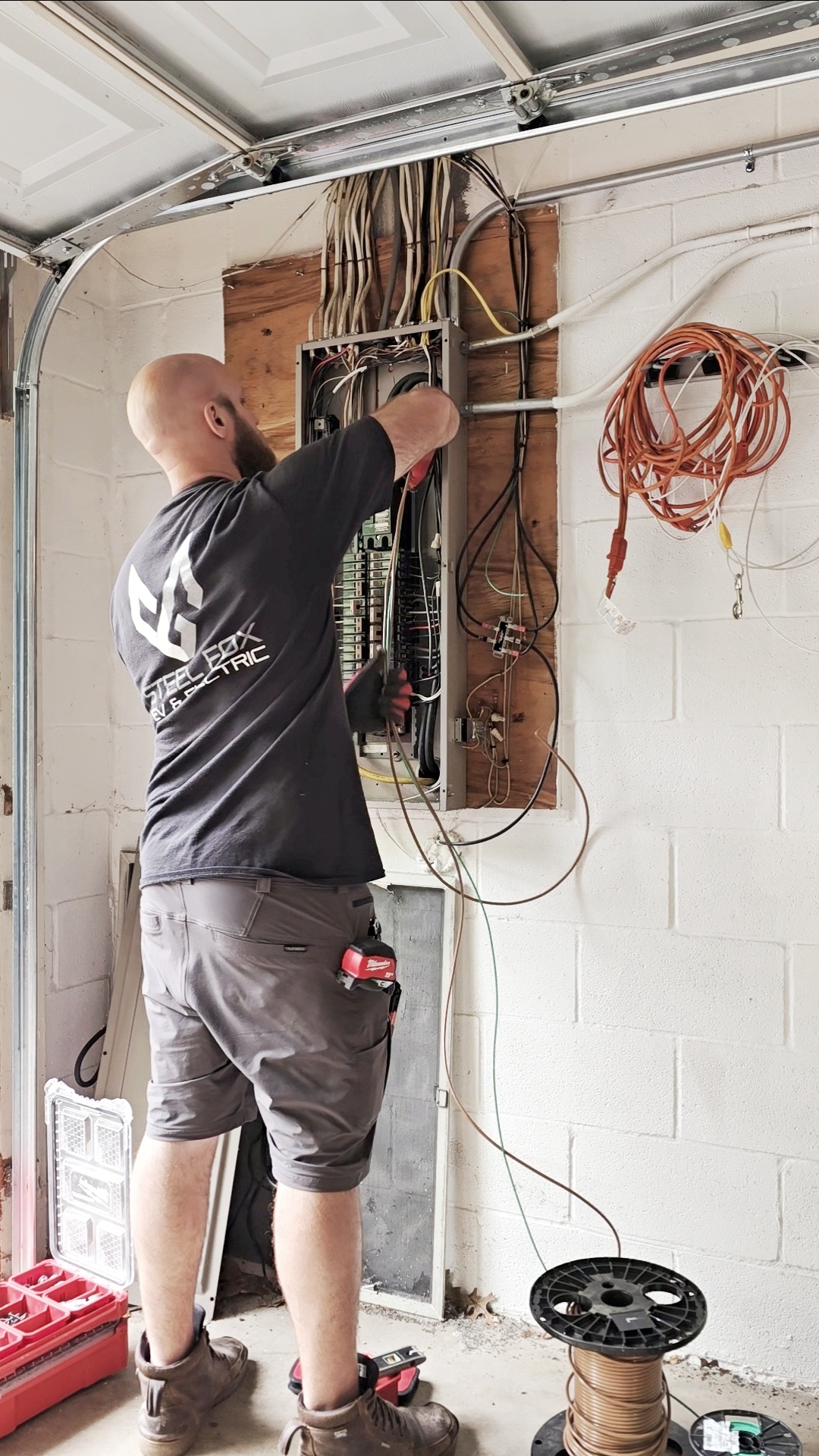 Steel Fox electrician working in Cutler-Hammer panel during Emporia EV charger install in Park Forest