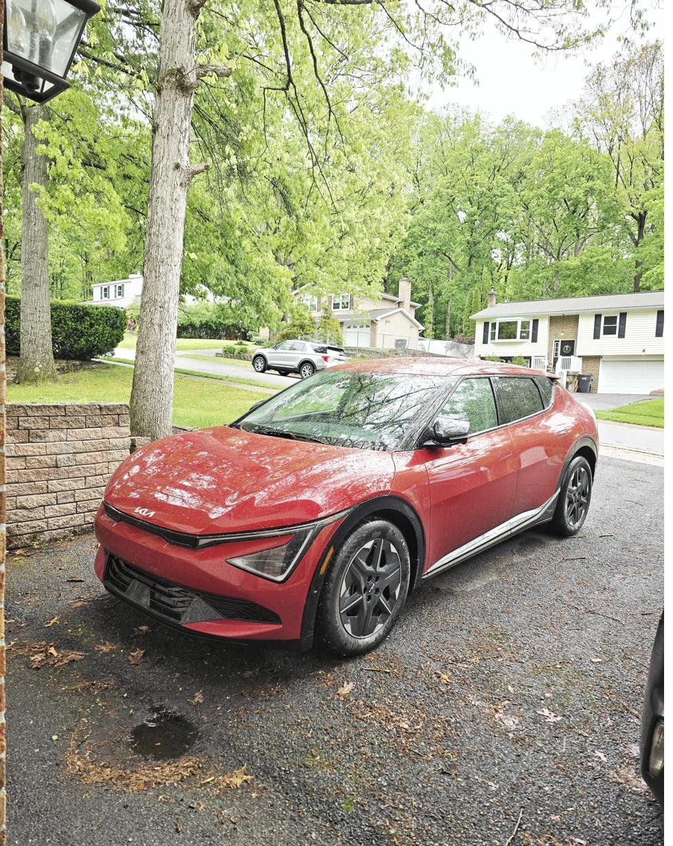 Red Kia EV6 in driveway after Emporia EV charger install in Park Forest, State College
