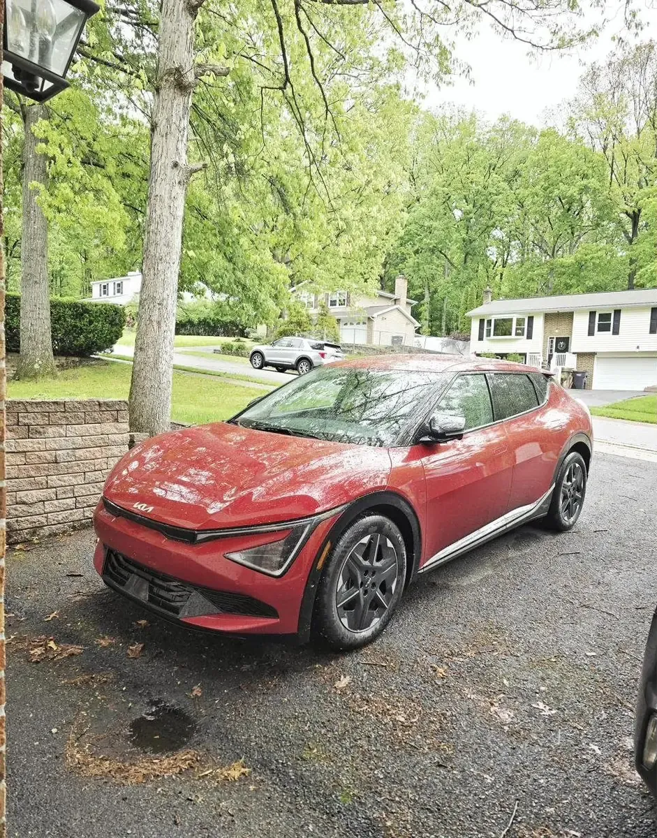 Red Kia EV6 in driveway after Emporia EV charger install in Park Forest, State College