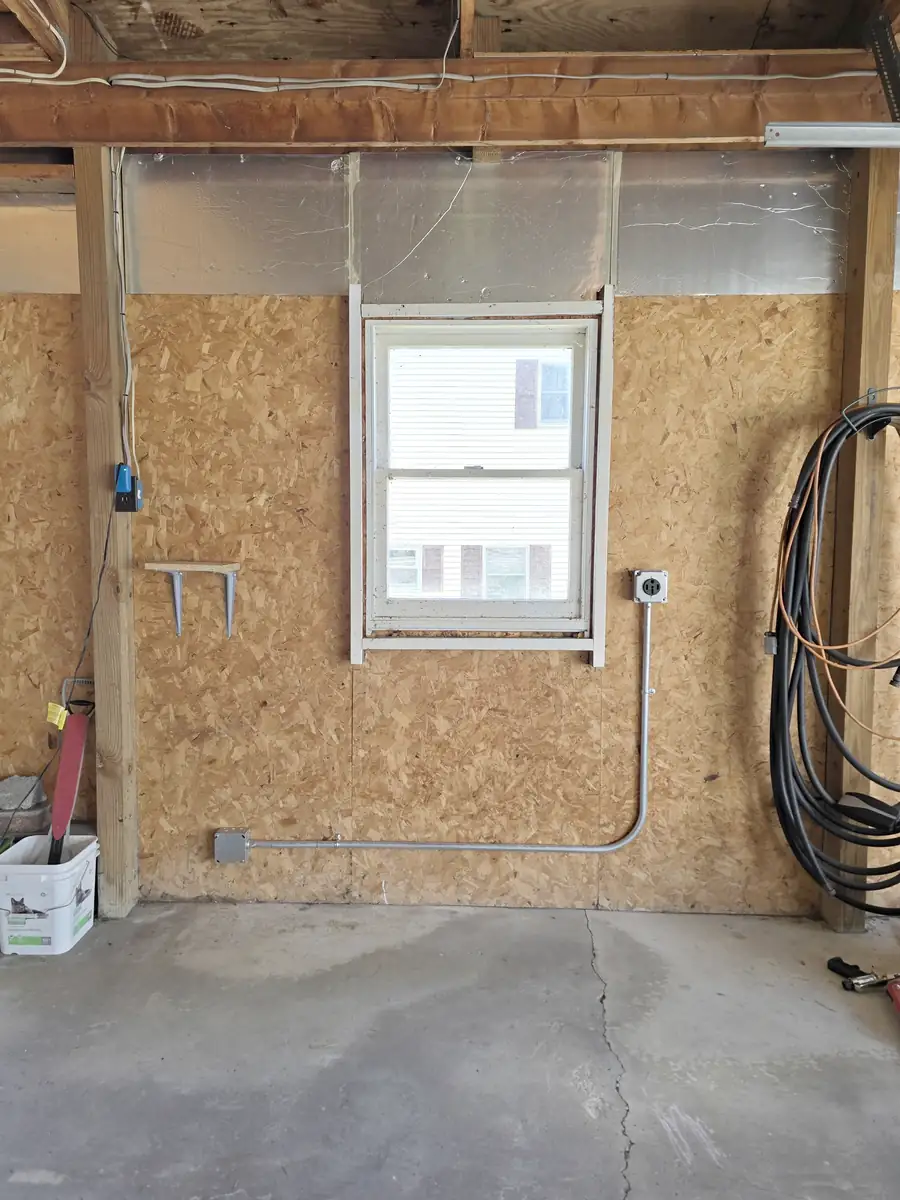 NEMA 14-50 outlet and EMT conduit installed inside the detached garage in Hawk Run