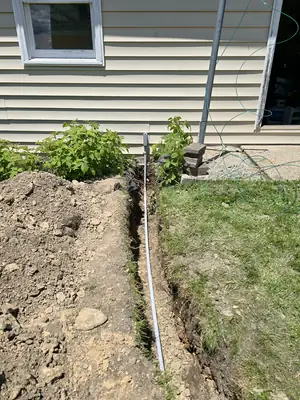 Buried conduit coming up the detached garage wall in Hawk Run · Steel Fox EV & Electric, Central PA