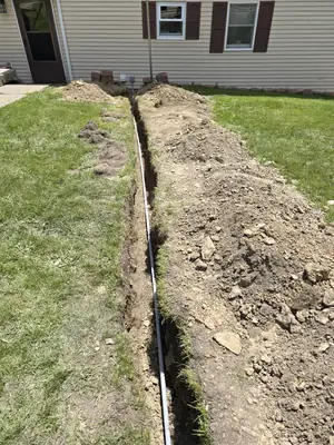 Trench across the yard for the underground feed to the detached garage in Hawk Run · Steel Fox EV & Electric, Central PA