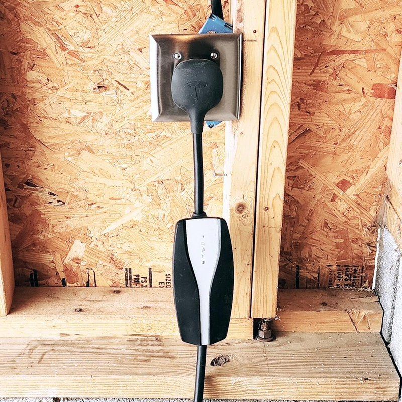Tesla Mobile Connector plugged into NEMA 14-50 outlet