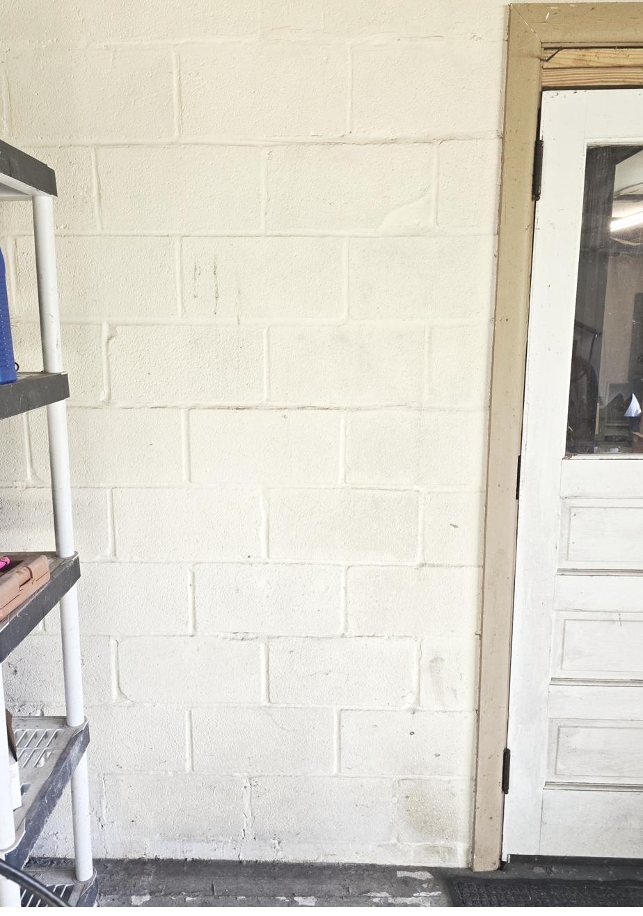 Painted concrete block garage wall before Tesla Universal Wall Connector install