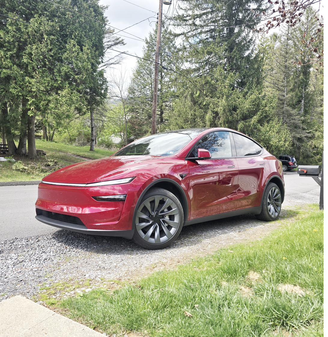 Red Tesla Model Y in driveway after Tesla Universal Wall Connector install in Bellefonte
