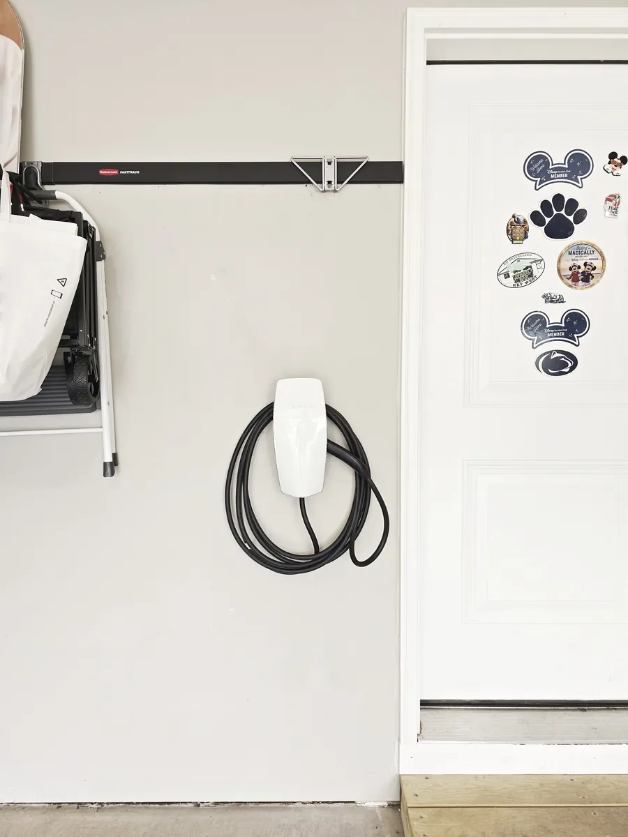 Finished Tesla Wall Connector installed in the Bellefonte garage with the cable neatly coiled