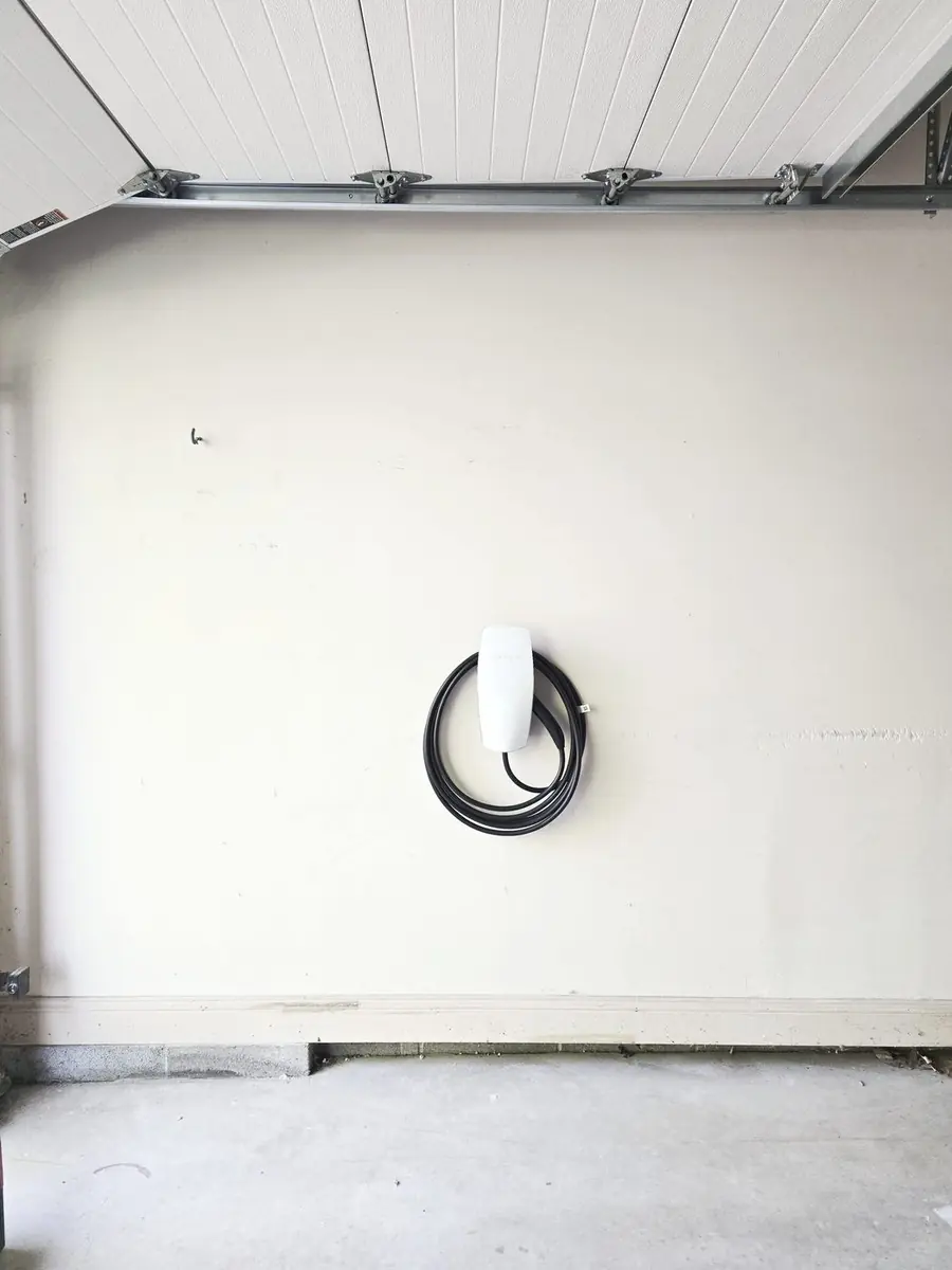 Tesla Wall Connector installed on garage wall in Grays Woods