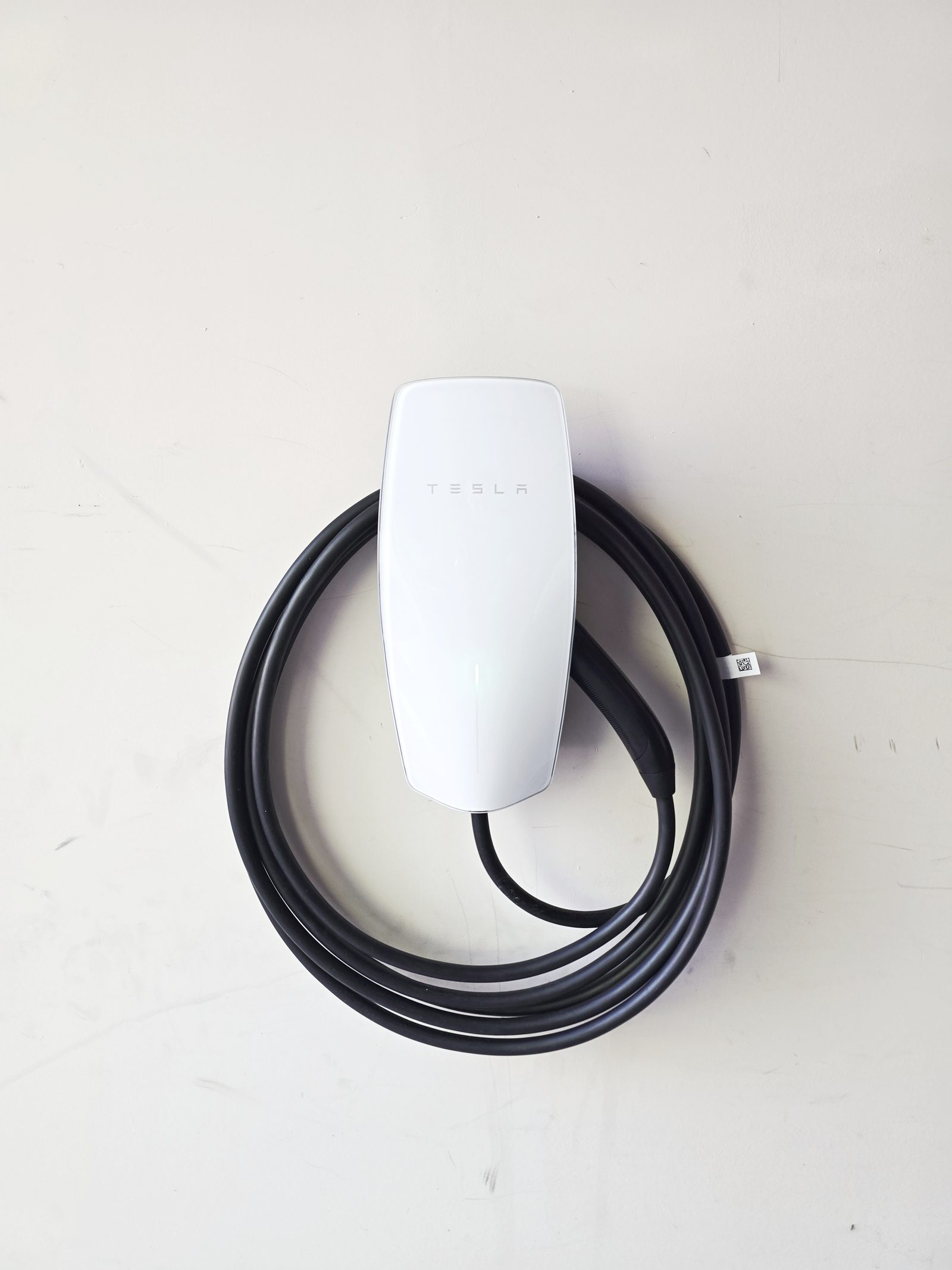 Tesla Wall Connector close-up with cable coiled