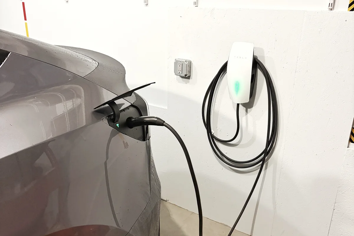Tesla Model Y charging from a hardwired Tesla Wall Connector installed in a Boalsburg, PA garage